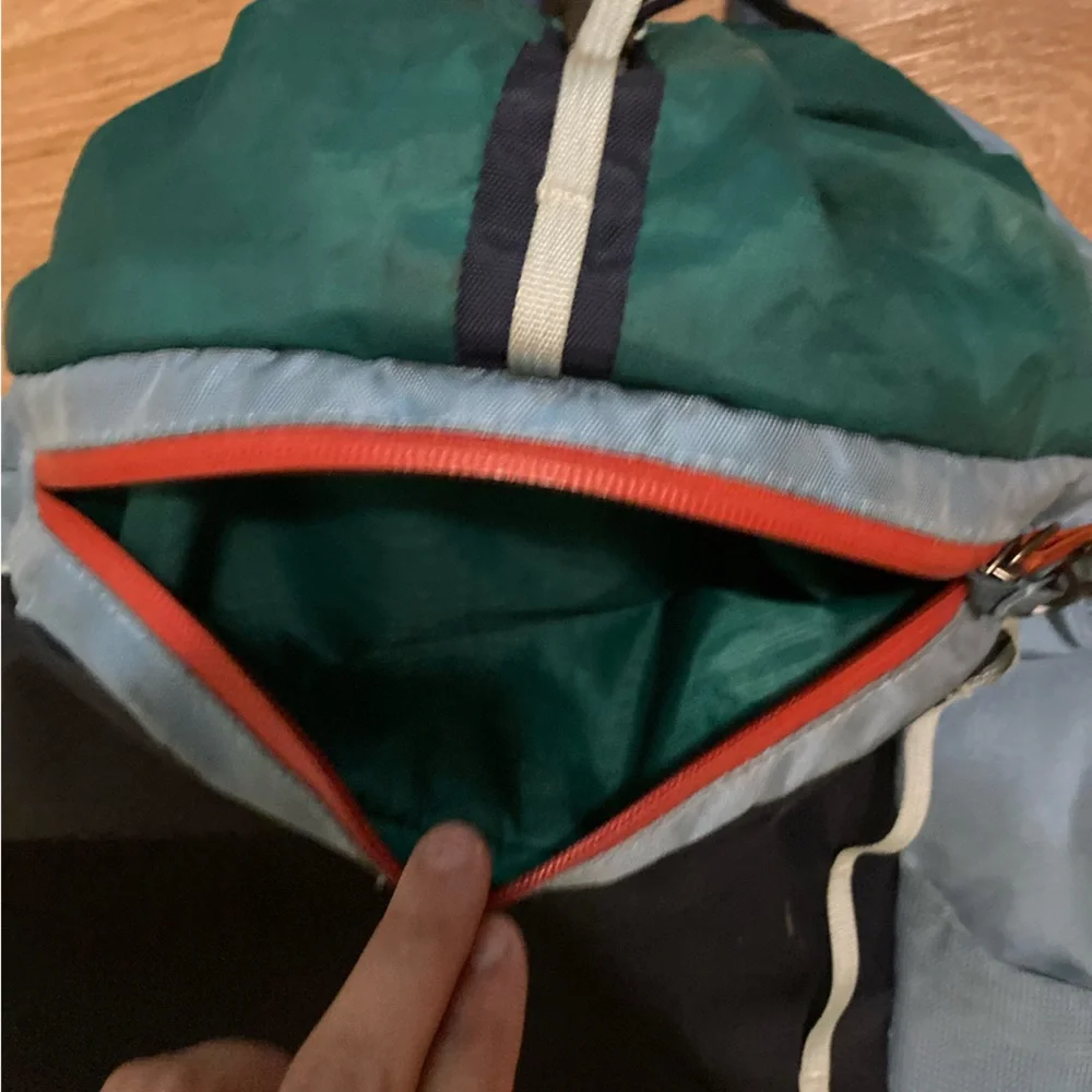 cotopaxi navy blue light blue green striped backpack